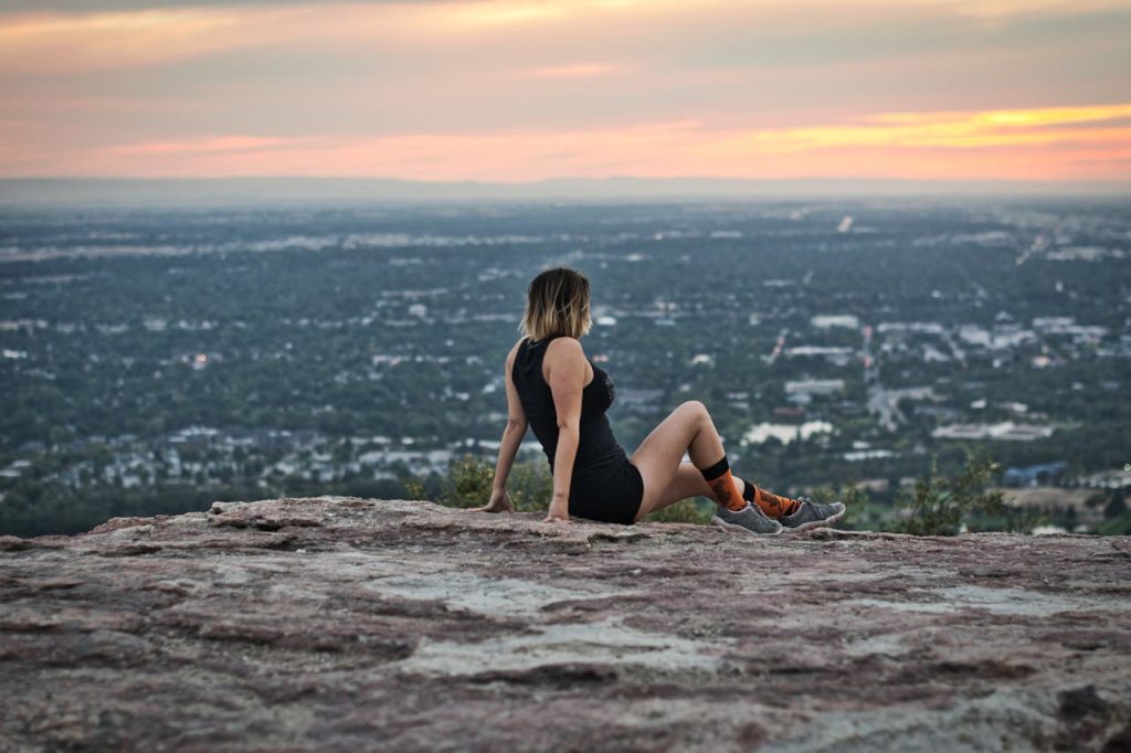 person-sitting-on-top-of-Table-Rock-overlooking-Boise-Idaho