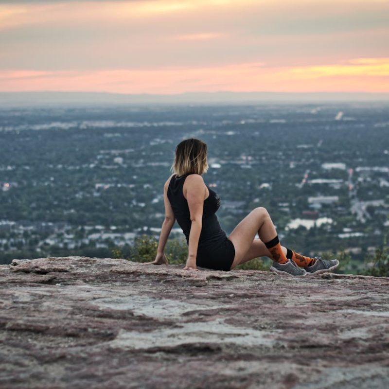 person-sitting-on-top-of-Table-Rock-overlooking-Boise-Idaho